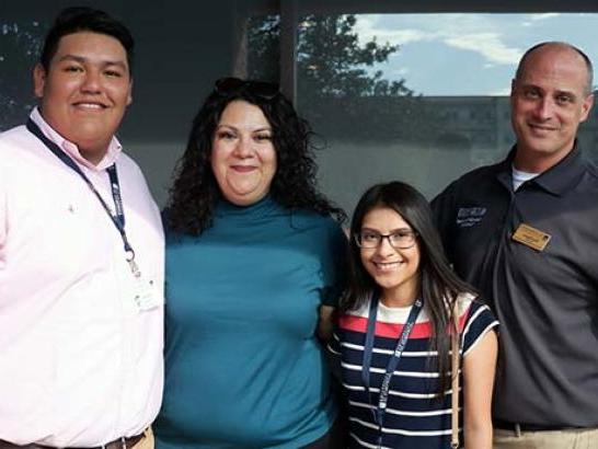 CAMP students and family members pose for a photo.